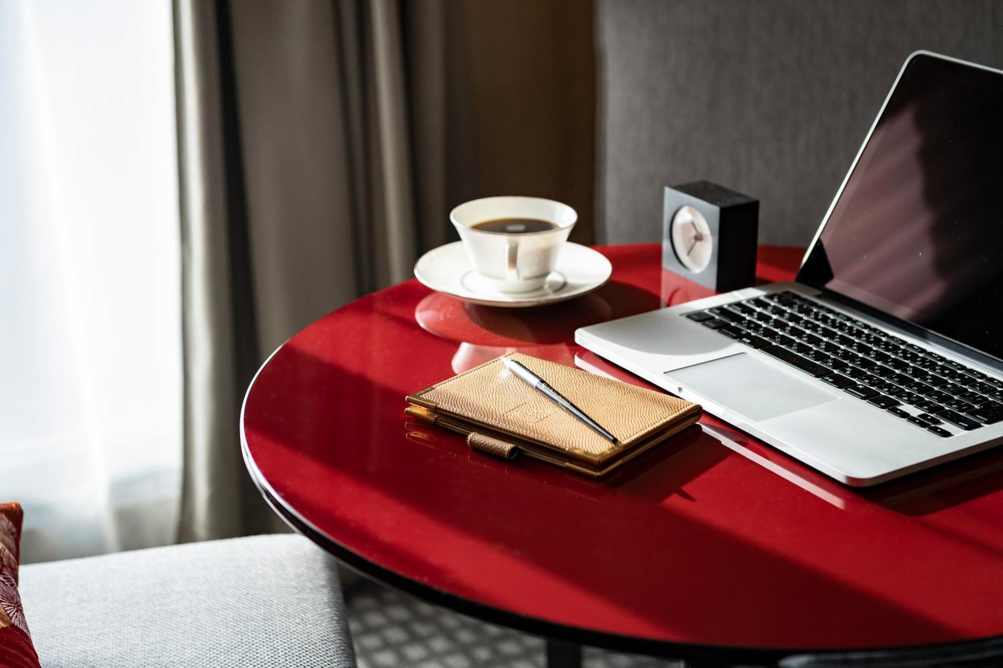 Kyoto Tokyu Hotel Esterno foto A table with a laptop, a cup of coffee, a notebook and a pen